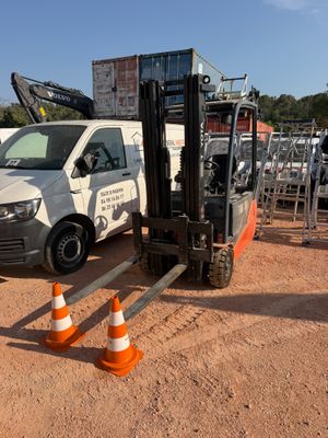 a white van parked in a lot with orange cones