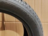 a close up of a tire on a cardboard box in a room