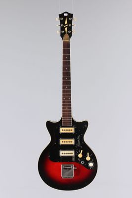 an electric guitar hanging from a string on a wall