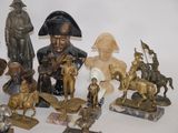a lot of bronze figurines that are on a table