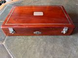 a small wooden box sitting on a table on the floor
