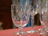 several empty wine glasses are sitting on a table with a red table cloth