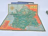 a map of france on a table next to a box of books