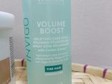 a close up of a bottle of volumee booster next to a container of conditionist