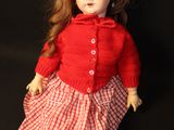 a doll that is sitting on a black surface