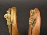 pair of antique brass plated wooden handles with chains on a black background