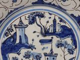 a blue and white plate with a picture of a castle on it
