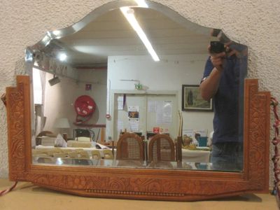 a man taking a picture of himself in the mirror