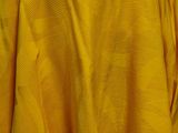 a yellow dress hanging on a hanger in a room