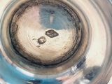 an image of a silver plate with a ring in it