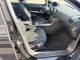 the interior of a car with the door open and the driver ' s seat down
