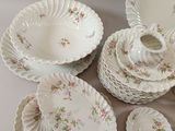 several pieces of porcelain dishes and bowls are arranged on a table