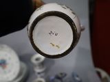 a close up of a vase on a table with other items