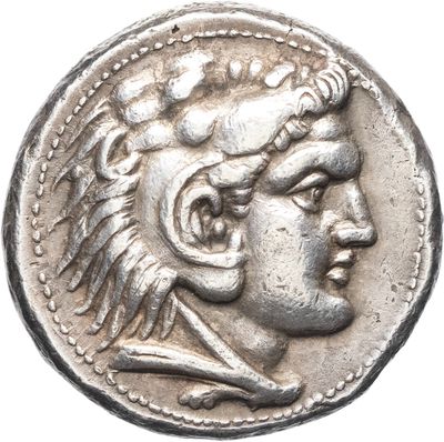 a silver coin with an image of a man wearing a headdress