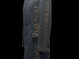 a grey coat with writing on it and a wooden stand