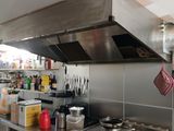 a kitchen with a stove, oven, and other items on the counter