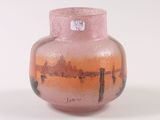 a pink vase with a painting on it sitting on a table