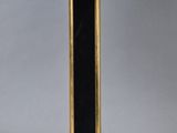 a close up of a lamp on a table with a black shade