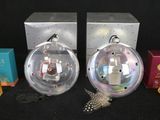 two christmas ornaments sitting next to each other on a table