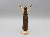 a statue of a woman holding her hands up in the air