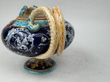 a blue and yellow vase with a snake on it