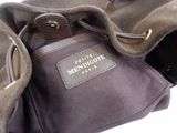 a purse with a tag on it sitting on a table