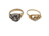 two gold and silver rings, one with a stone and the other with a diamond