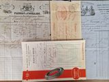 some old papers are sitting on a table with a pair of scissors