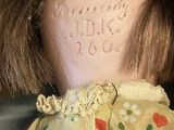 a close up of a doll with a tag on it ' s head