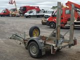 a trailer with a crane attached to it in a parking lot