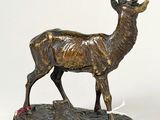 bronze statue of a stag with antlers on a base