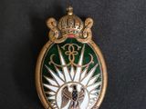 a close up of a badge with a crown on it