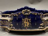an image of a blue and gold bowl with a lion on it