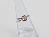 a ring that is sitting on top of a clear vase