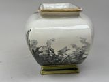 a white vase with a black and white design on it
