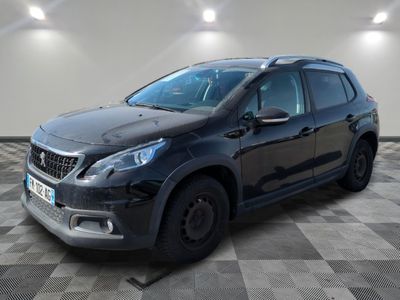 une voiture noire garée dans une pièce au sol en damier