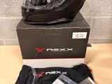 the box is full of items including a helmet, t - shirt, and gloves