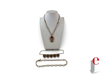 a necklace, bracelet, and ring on display on a mannequin