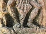 a statue of a man sitting on top of a table
