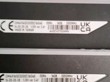 two black and white labels on the back of a laptop
