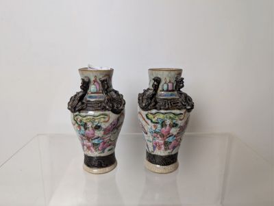 two vases that are sitting on a glass table