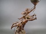 bronze statue of a woman holding a vase with a man on it