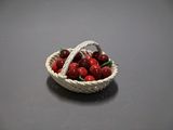 a small basket of cherries sitting on a table