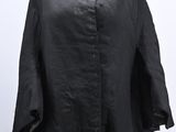 the black shirt is on a mannequin stand with a white background