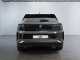 the rear end of a grey car parked in a garage