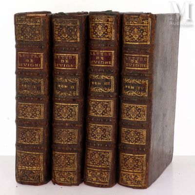 three old books sitting on top of each other on a table