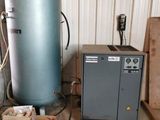 an image of a room with a water heater and other items on the floor