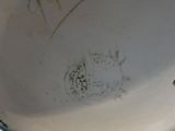 a close up of a white bowl with writing on it