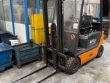 a fork lift truck parked in front of a building