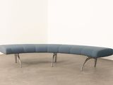 an image of a curved bench in a room with a white wall